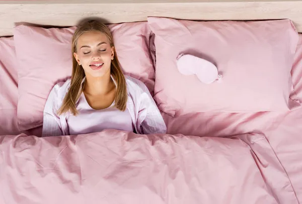Top View Blonde Woman Sticking Out Tongue Sleep Mask Bed — Stock Photo, Image