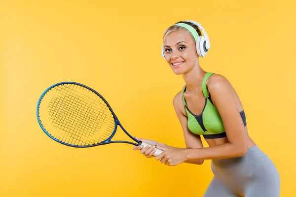 Smiling Sportswoman Headphones Playing Tennis Isolated Yellow — Stock Photo, Image