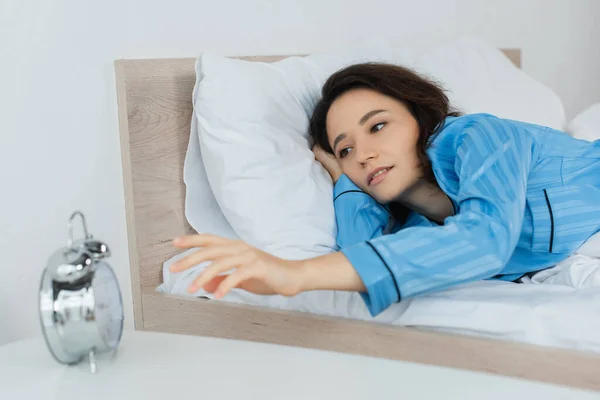 Sleepy Woman Reaching Alarm Clock Morning — Stock Photo, Image