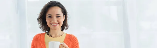 Pleased Young Woman Smiling Holding Cup White Curtain Banner — Stock Photo, Image