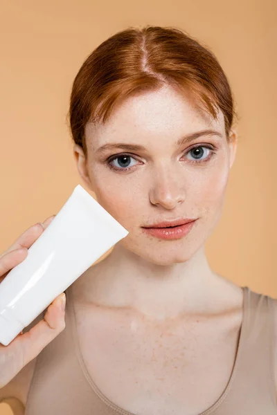 Portrait Freckled Woman Holding Tube Cream Isolated Beige — Stok Foto