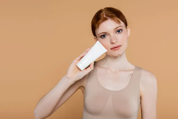 Young Redhead Woman Posing Body Lotion Isolated Beige — Stock Photo, Image