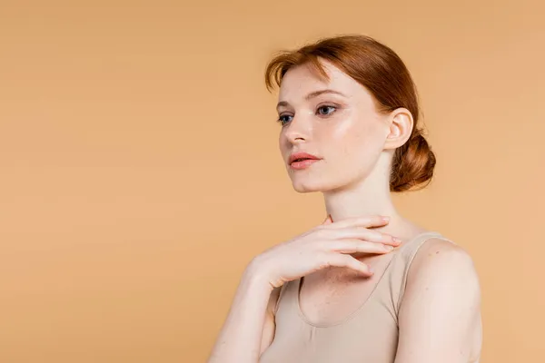 Pretty Redhead Woman Touching Neck Isolated Beige — Stock Photo, Image