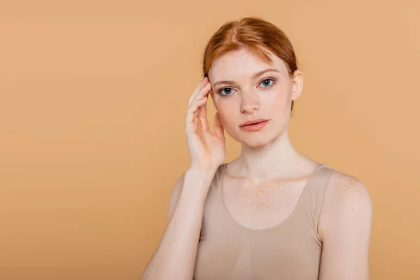 Portrait Young Freckled Woman Touching Face Looking Camera Isolated Beige — Stock Photo, Image