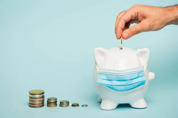 Cropped View Man Putting Coin Piggy Bank Medical Mask Blue — Stock Photo, Image