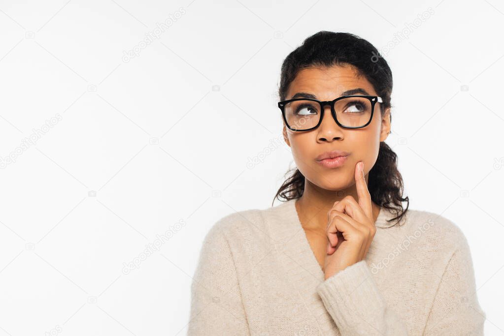 Thoughtful african american woman in eyeglasses looking up isolated on white