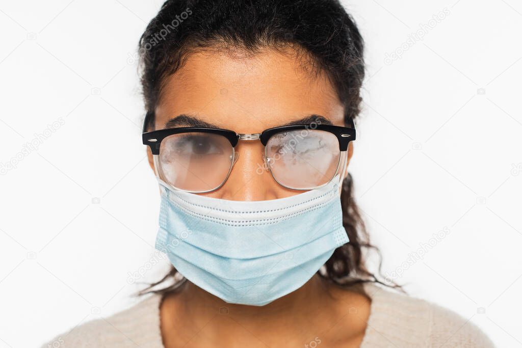 African american woman in fogged eyeglasses and medical mask isolated on white
