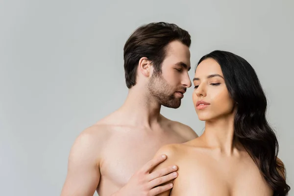 Young Shirtless Man Touching Nude Brunette Woman Isolated Grey — Stockfoto