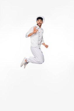 Şapkalı, üniformalı, zıplayan ve beyazda iyi gözüken aşçı. 