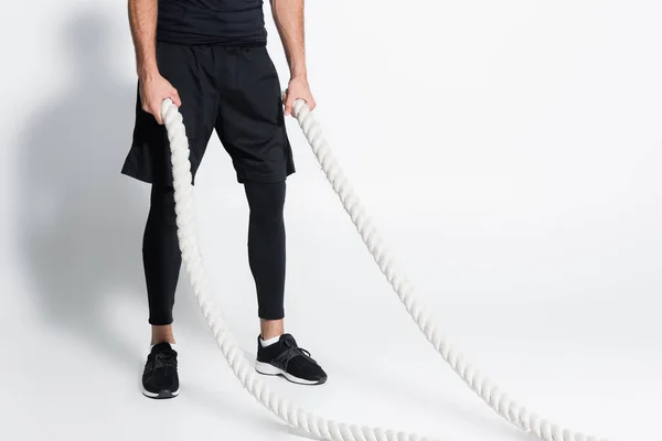 Cropped View Sportsman Holding Battle Ropes Grey Background — Stockfoto