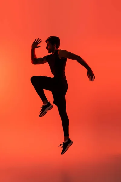 Side View Sportsman Jumping Red Background — Stock Photo, Image