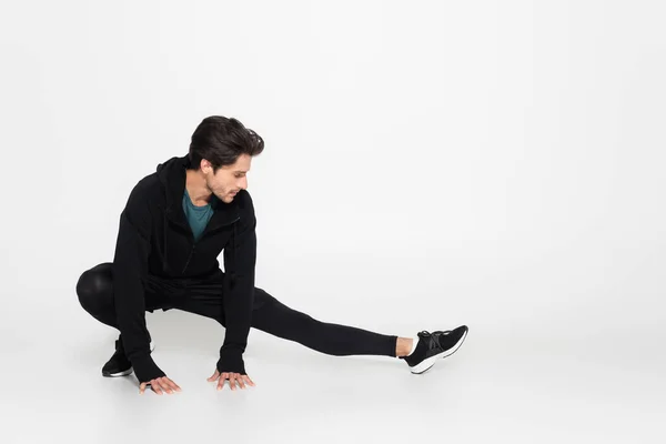 Brunette Sportsman Stretching Grey Background — Stock Photo, Image