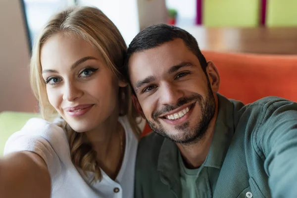 Excited Blonde Woman Young Man Looking Camera Restaurant — Stockfoto