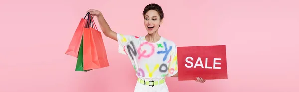 Astonished Happy Woman Holding Red Card Sale Lettering Shopping Bags — Stockfoto