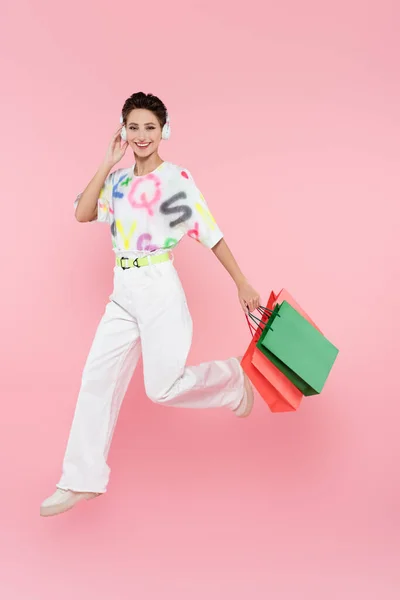 Full Length View Cheerful Woman Headphones Running Shopping Bags Pink — Stockfoto