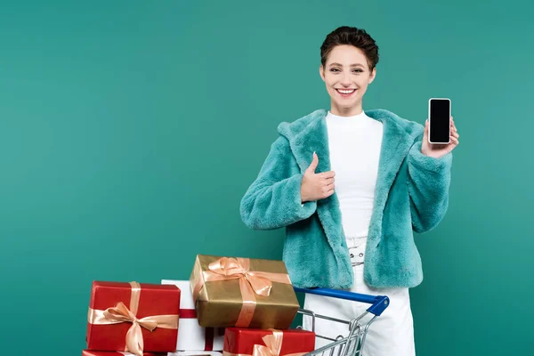 Smiling Woman Showing Thumb While Holding Smartphone Blank Screen Shopping — стоковое фото