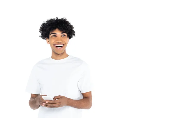 Excited African American Man Looking Away While Messaging Smartphone Isolated — Stock Photo, Image