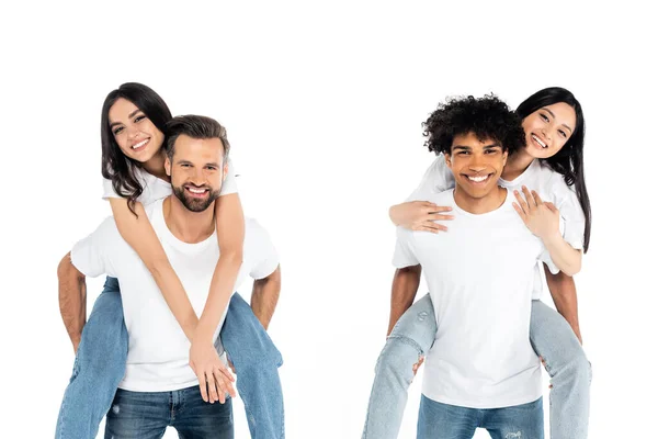 Multicultural Men Smiling Camera While Piggybacking Pleased Women Isolated White — Foto Stock