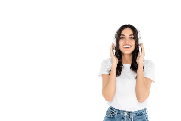 Happy Brunette Woman Touching Headphones While Smiling Camera Isolated White — 스톡 사진