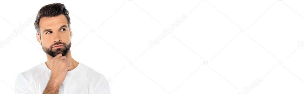 pensive man holding hand near chin and looking away while thinking isolated on white, banner
