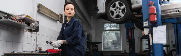 Young Forewoman Holding Tool Car Service Banner — Stockfoto
