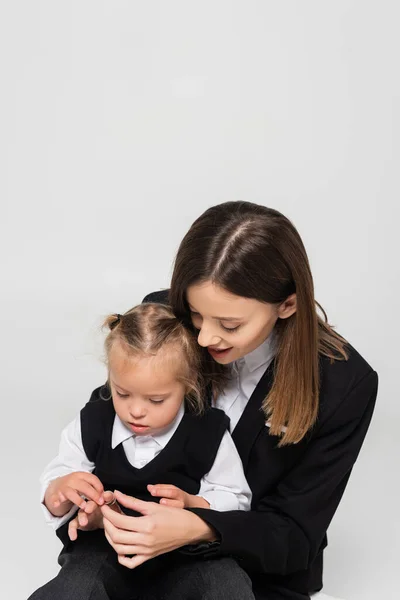 Cheerful Mother Touching Hand Child Syndrome Isolated Grey — Stockfoto