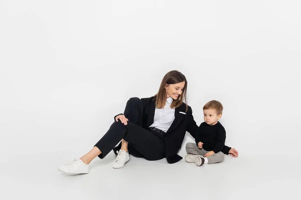 Stylish Cheerful Woman Sitting Toddler Son Grey — Stock Photo, Image
