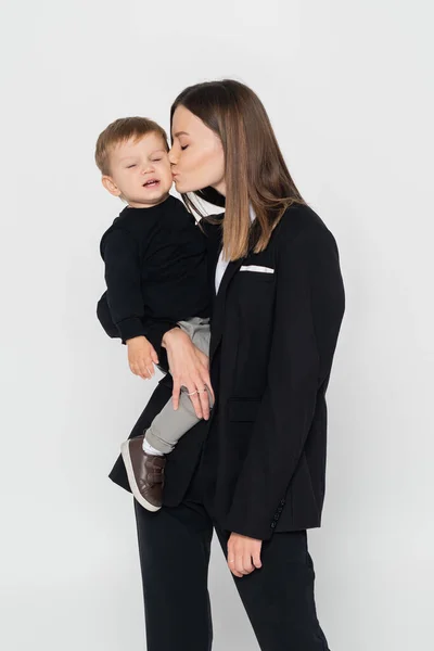Young Woman Holding Arms Kissing Toddler Son Isolated Grey — Fotografia de Stock
