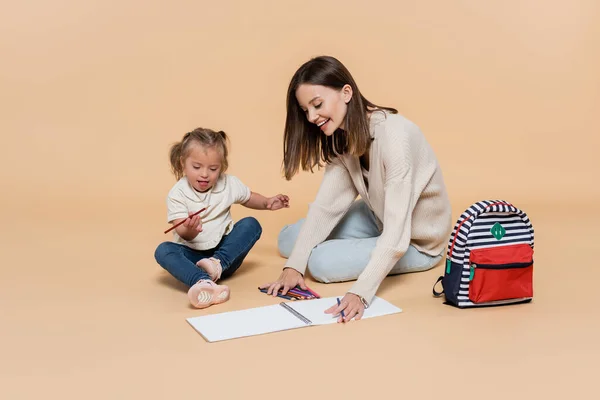 Happy Mother Sitting Kid Syndrome Drawing Colorful Pencils Backpack Beige — Stock Photo, Image