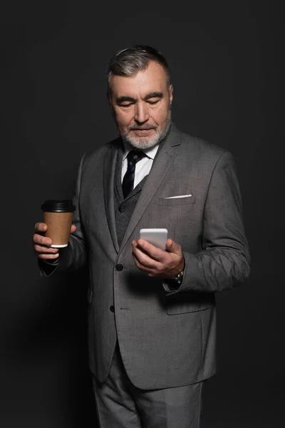 Stylish Senior Businessman Holding Paper Cup While Looking Mobile Phone — Stok fotoğraf