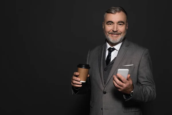 Pleased Senior Businessman Coffee Smartphone Looking Camera Dark Grey — Stock Photo, Image