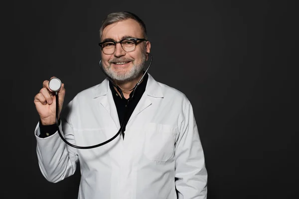 Cheerful Senior Doctor Eyeglasses Holding Stethoscope Isolated Black — Stock Photo, Image