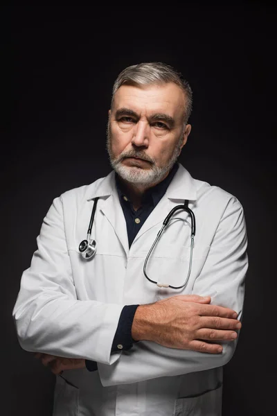 Senior Bearded Doctor Stethoscope Neck Standing Crossed Arms Isolated Black — Zdjęcie stockowe