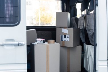 Adhesive tape on carton boxes with signs in car 
