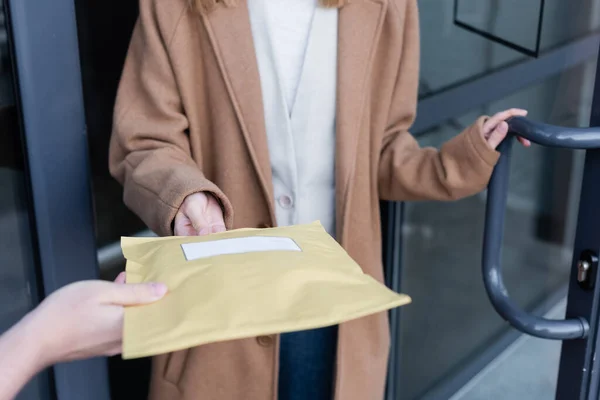 Cropped View Courier Holding Parcel Blurred Woman Building Outdoors — ストック写真