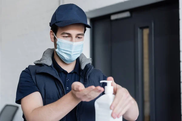 Delivery Man Medical Mask Applying Blurred Hand Sanitizer Office — Foto de Stock