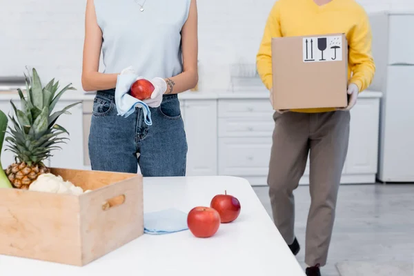 Cropped View Woman Latex Gloves Cleaning Apple Boyfriend Carrying Carton — Stock Photo, Image