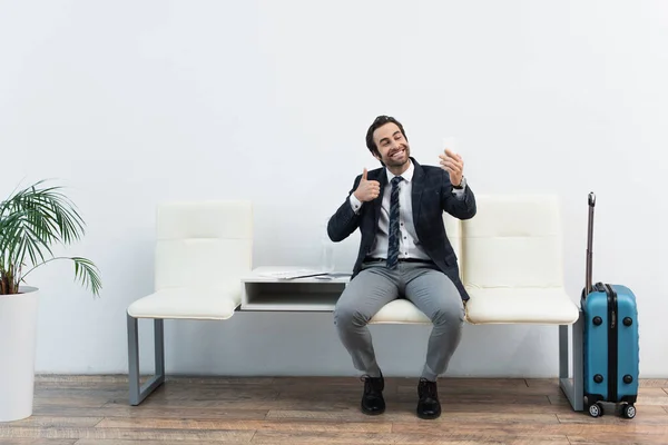 Cheerful Man Showing Thumb While Taking Selfie Smartphone Departure Lounge — Stock Photo, Image