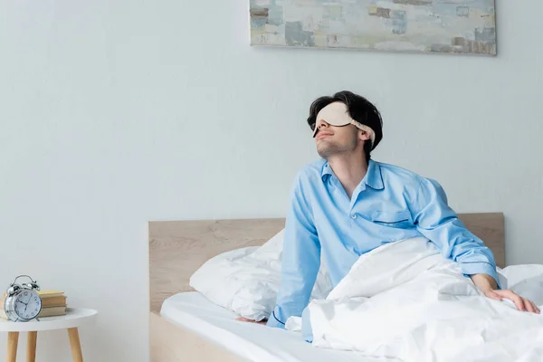 Man Sleep Mask Sitting Bed Vintage Alarm Clock Bedside Table — Stock Photo, Image