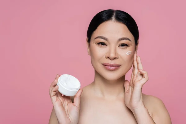 Smiling Asian Woman Naked Shoulders Applying Cream Face Isolated Pink — Stock Photo, Image