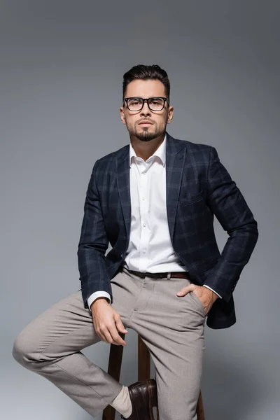 Bearded Businessman Blazer Glasses Sitting Chair Posing Hand Pocket Isolated — Stock Photo, Image