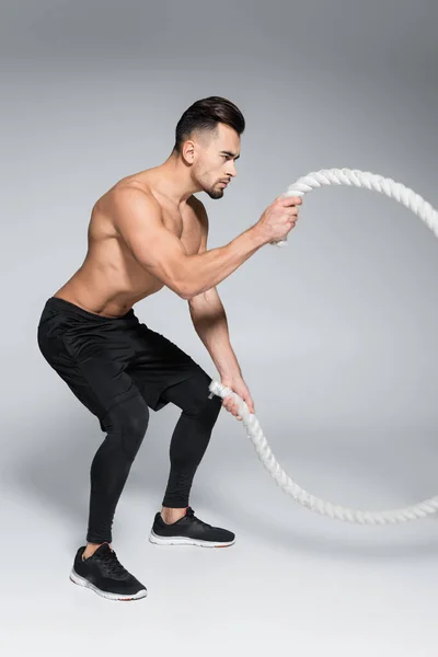 Full Length Strong Sportsman Exercising Battle Ropes Grey — Stock Photo, Image