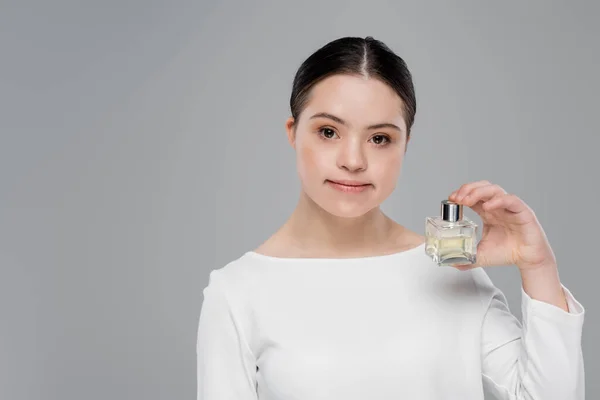 Jonge Vrouw Met Dons Syndroom Houdt Parfum Geïsoleerd Grijs — Stockfoto