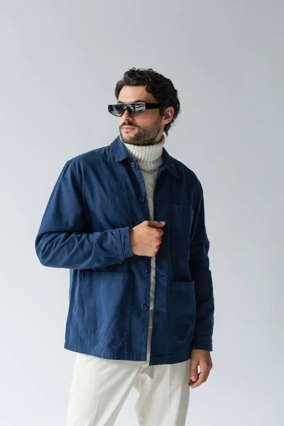 Trendy Man Dark Sunglasses Blue Jacket Looking Away Isolated Grey — Stock Photo, Image