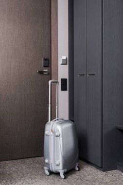 grey luggage in modern hotel room  clipart