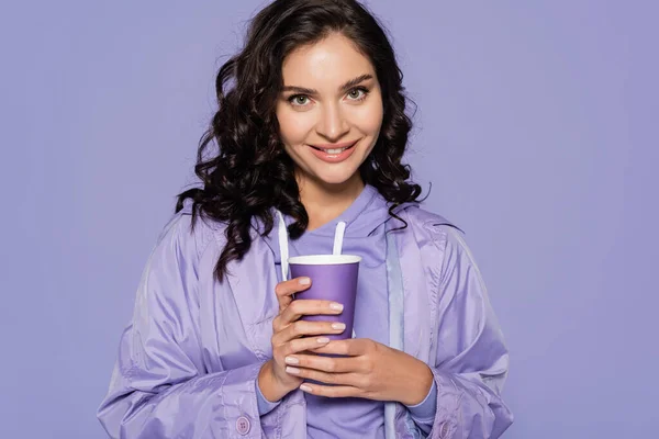 Cheerful Young Woman Raincoat Holding Paper Cup Isolated Purple — Stock Photo, Image