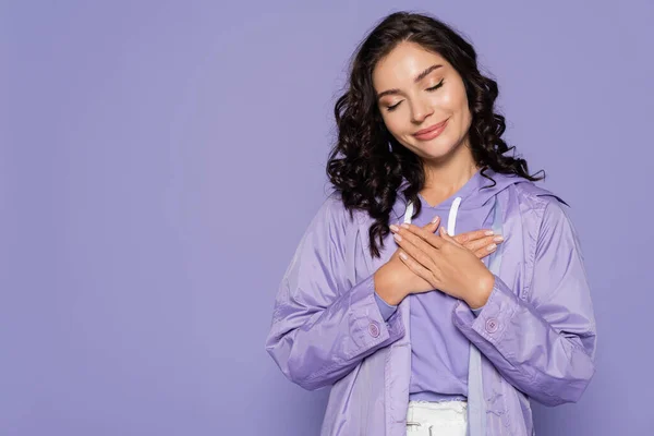 Pleased Young Woman Raincoat Holding Hands Chest Isolated Purple — Stock Photo, Image