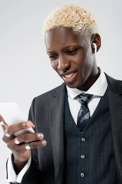 Cheerful African American Man Wireless Earphone Using Smartphone Isolated Grey — Stock Photo, Image