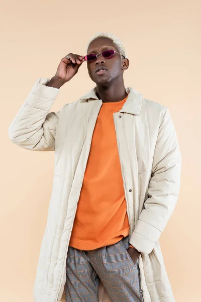 Young African American Man Coat Adjusting Stylish Sunglasses While Posing — Stock Photo, Image