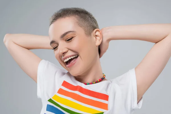 興奮した女性の目を閉じてLgbt色のTシャツグレーに隔離されたポーズ — ストック写真